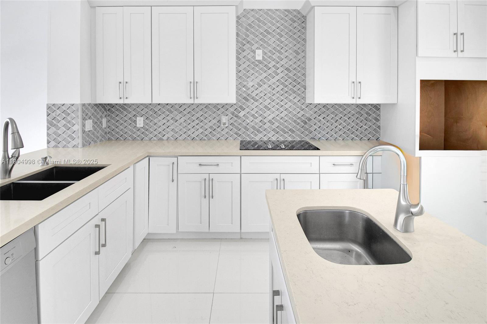 425 Southwest 129th Avenue Miami, FL 33184 - Photo 9 of 24 a kitchen with white cabinets a sink and dishwasher