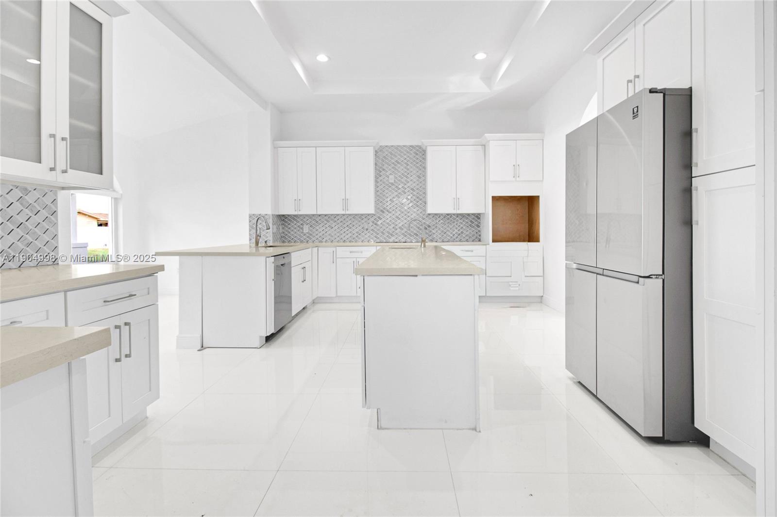 425 Southwest 129th Avenue Miami, FL 33184 - Photo 10 of 24 a kitchen with white cabinets and refrigerator