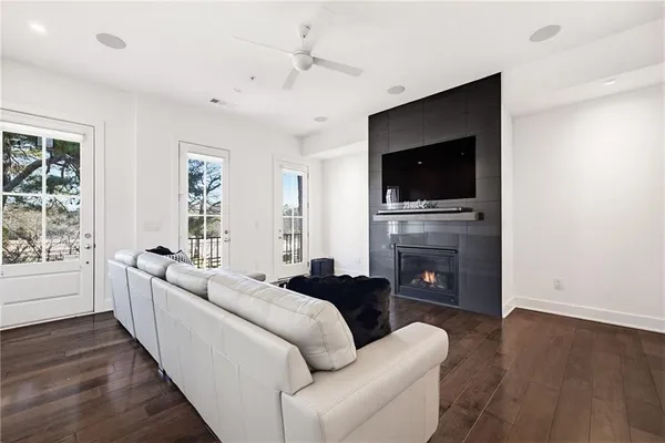 a living room with fireplace furniture and a flat screen tv