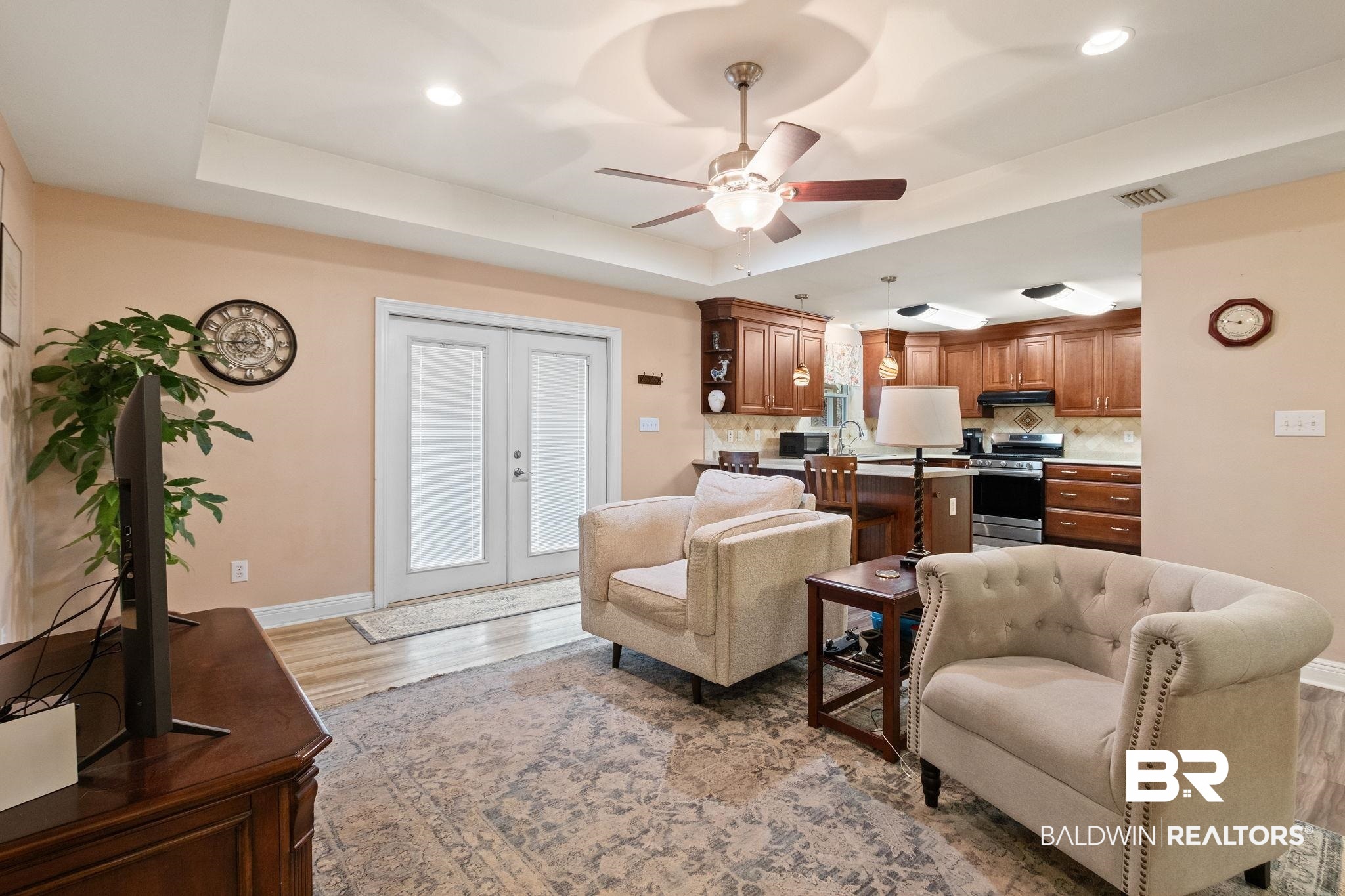 24250 Hack Road Bay Minette, AL 36507 - Photo 7 of 88 Living area featuring french doors, a ceiling fan, a tray ceiling, light wood-style floors, and recessed lighting
