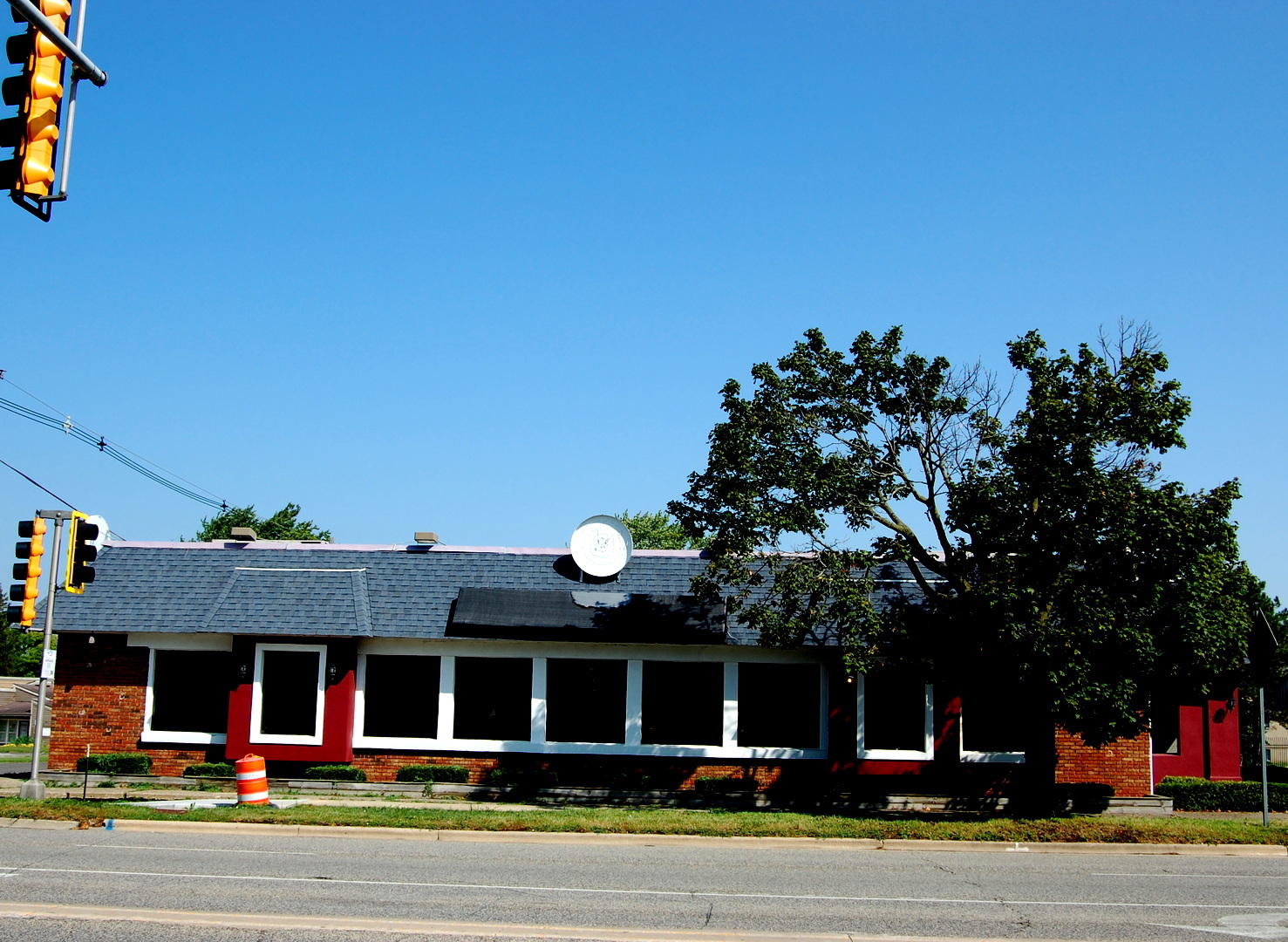 a front view of a building and trees