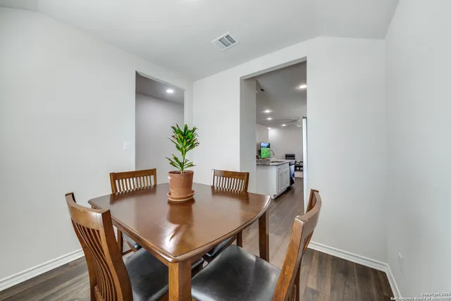 a view of a dining room with furniture and wooden floor