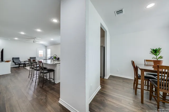 a view of a dining room with furniture and wooden floor