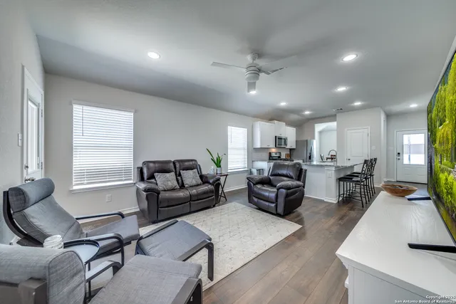 a living room with furniture and a large window