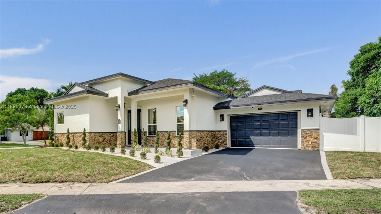 300 North 53 Avenue Hollywood, FL 33021 - Photo 2 of 77 a front view of a house with a yard and garage