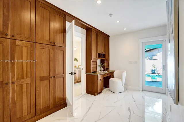 a bedroom with a bed couch and a window