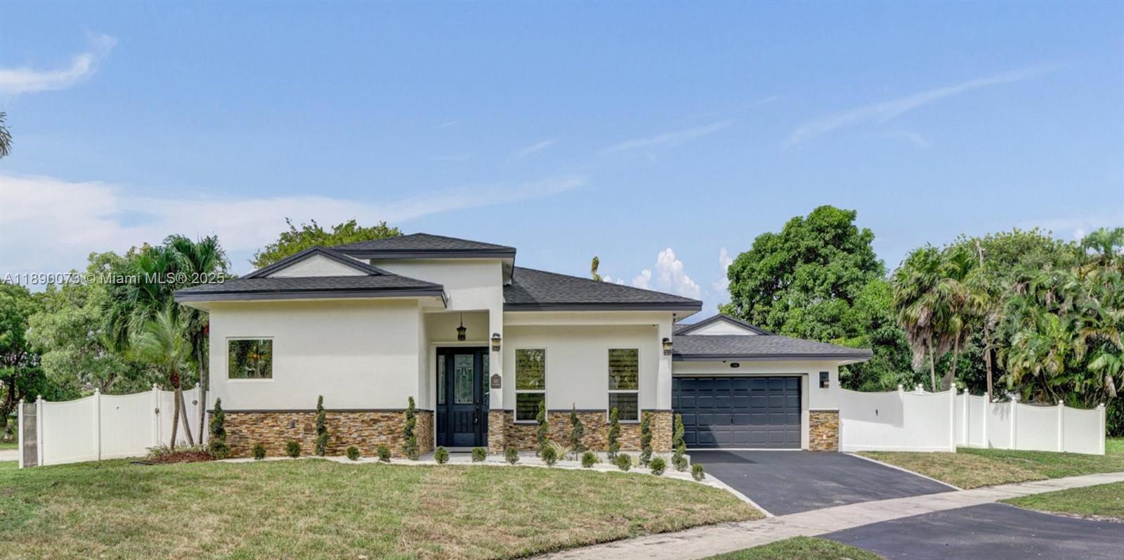 300 North 53 Avenue Hollywood, FL 33021 - Photo 3 of 77 a front view of a house with garden