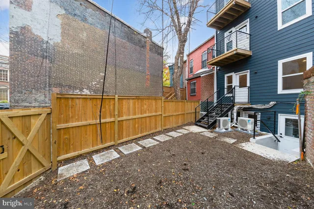 a view of a house with a wooden fence
