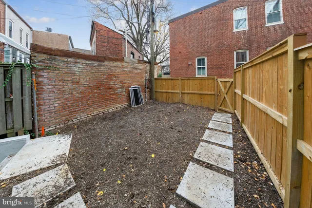 a view of a brick house that has large door