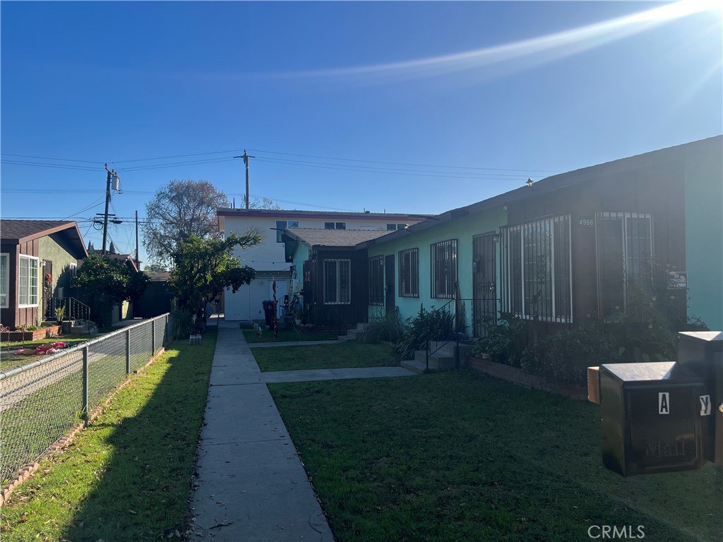 4966 Oregon Avenue, Unit D Long Beach, CA 90805 - Photo 1 of 5 a view of a backyard with potted plants and a fountain