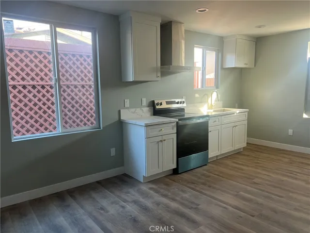 a kitchen with a sink stove and cabinets