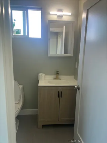 a utility room with a sink toilet and window