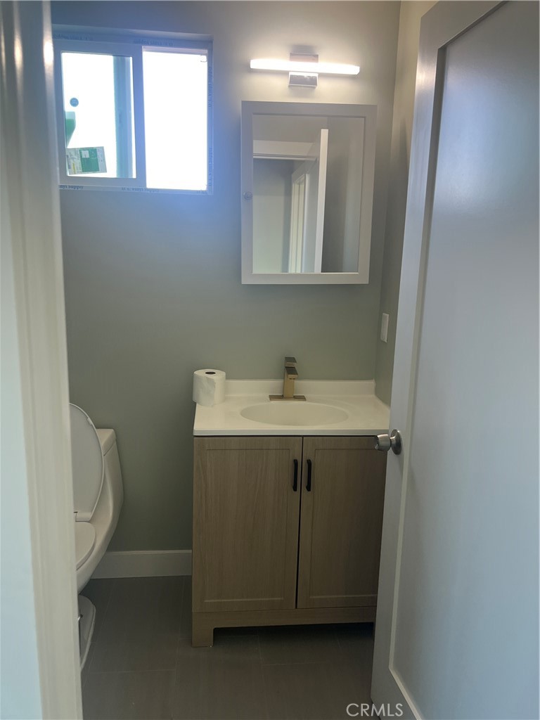 4966 Oregon Avenue, Unit D Long Beach, CA 90805 - Photo 5 of 5 a utility room with a sink toilet and window