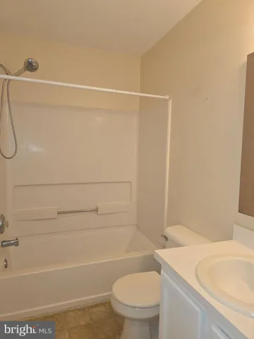 a bathroom with a toilet and a bathtub