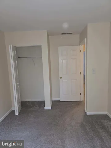 an empty room with closet area
