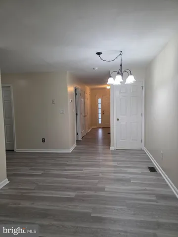 a view of a room with wooden floor