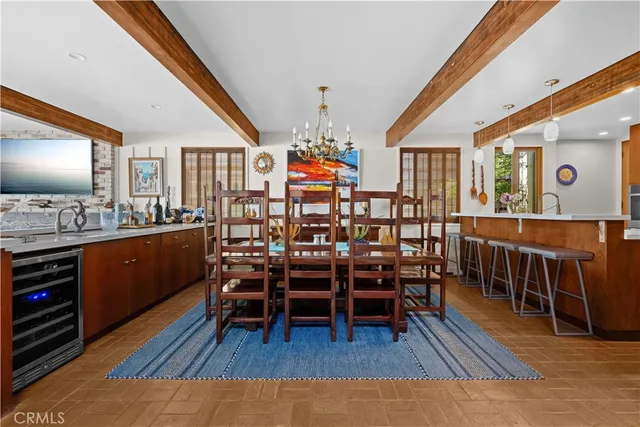 a kitchen with kitchen island a stove a refrigerator and a dining table