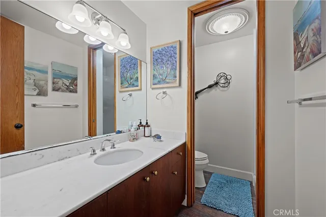 a living room with furniture and a painting on the wall