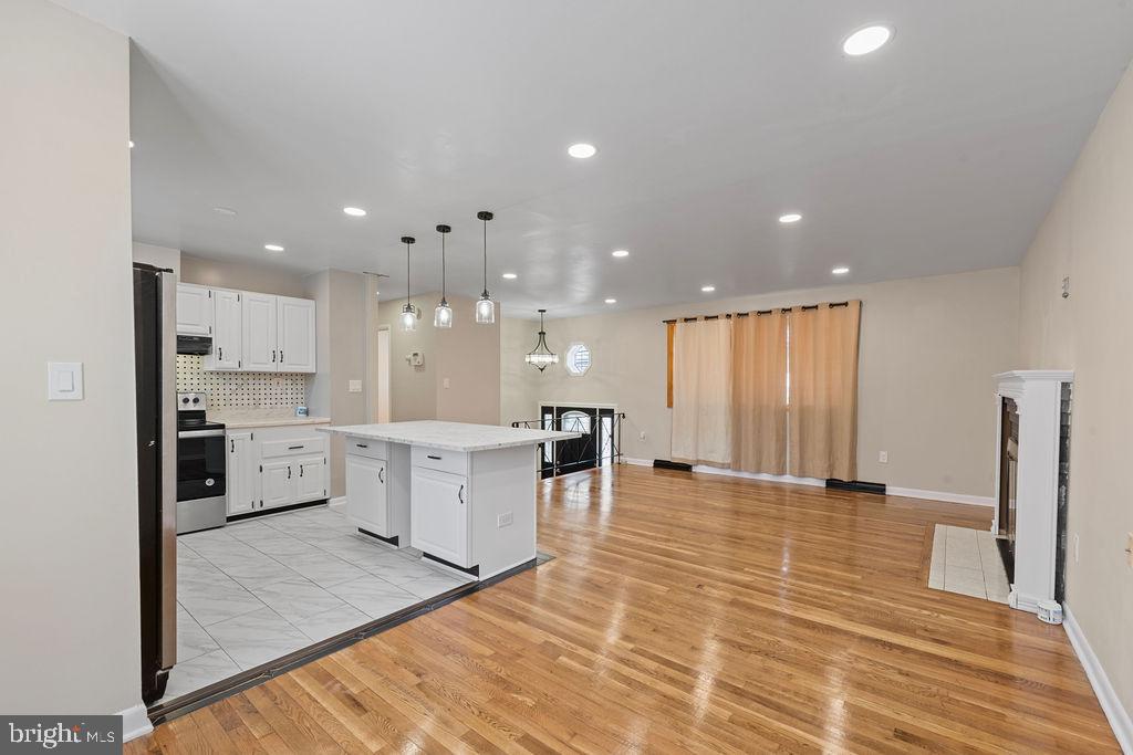 8003 Allentown Road Fort Washington, MD 20744 - Photo 11 of 43 a large kitchen with a large counter top appliances and cabinets