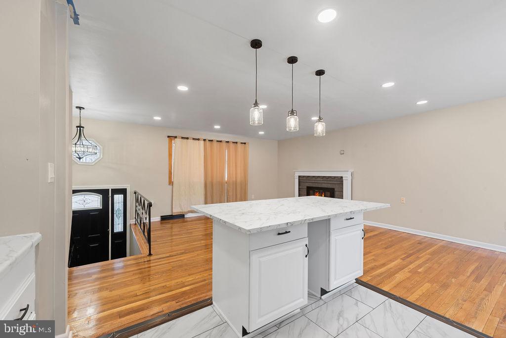 8003 Allentown Road Fort Washington, MD 20744 - Photo 12 of 43 a view of a kitchen with kitchen island a chandelier and wooden floor