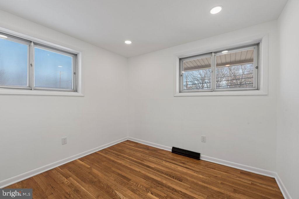 8003 Allentown Road Fort Washington, MD 20744 - Photo 15 of 43 a view of an empty room with wooden floor and a window