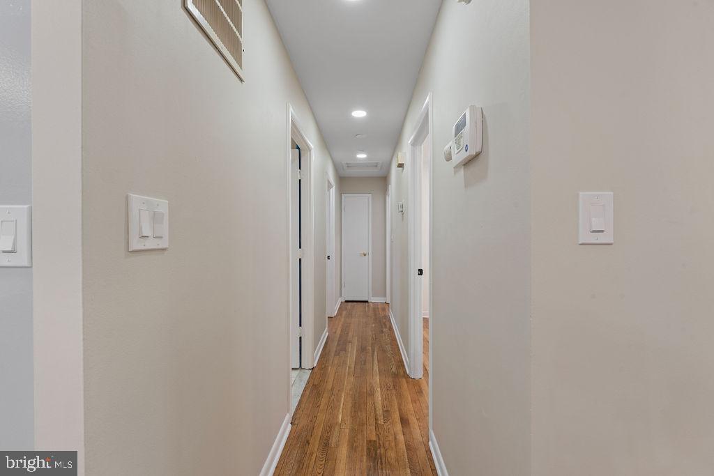 8003 Allentown Road Fort Washington, MD 20744 - Photo 21 of 43 a view of a hallway with wooden floor and staircase