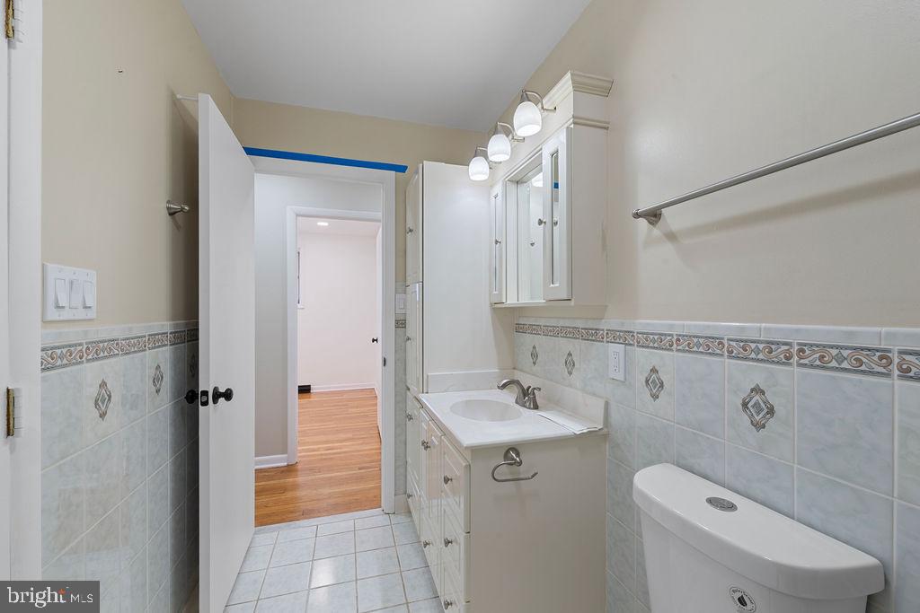 8003 Allentown Road Fort Washington, MD 20744 - Photo 25 of 43 a bathroom with a sink a toilet and shower