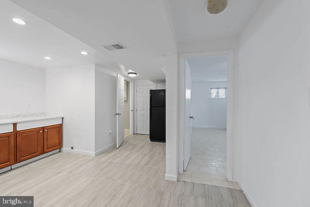8003 Allentown Road Fort Washington, MD 20744 - Photo 27 of 43 an empty room with wooden floor and cabinet