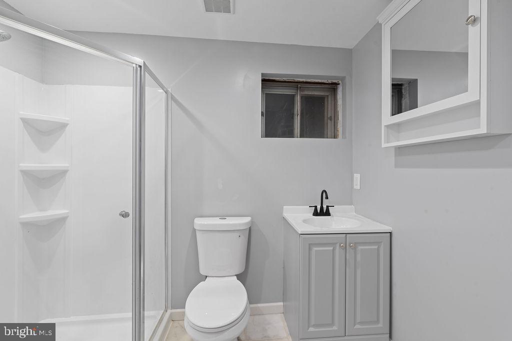 8003 Allentown Road Fort Washington, MD 20744 - Photo 30 of 43 a bathroom with a toilet sink and mirror