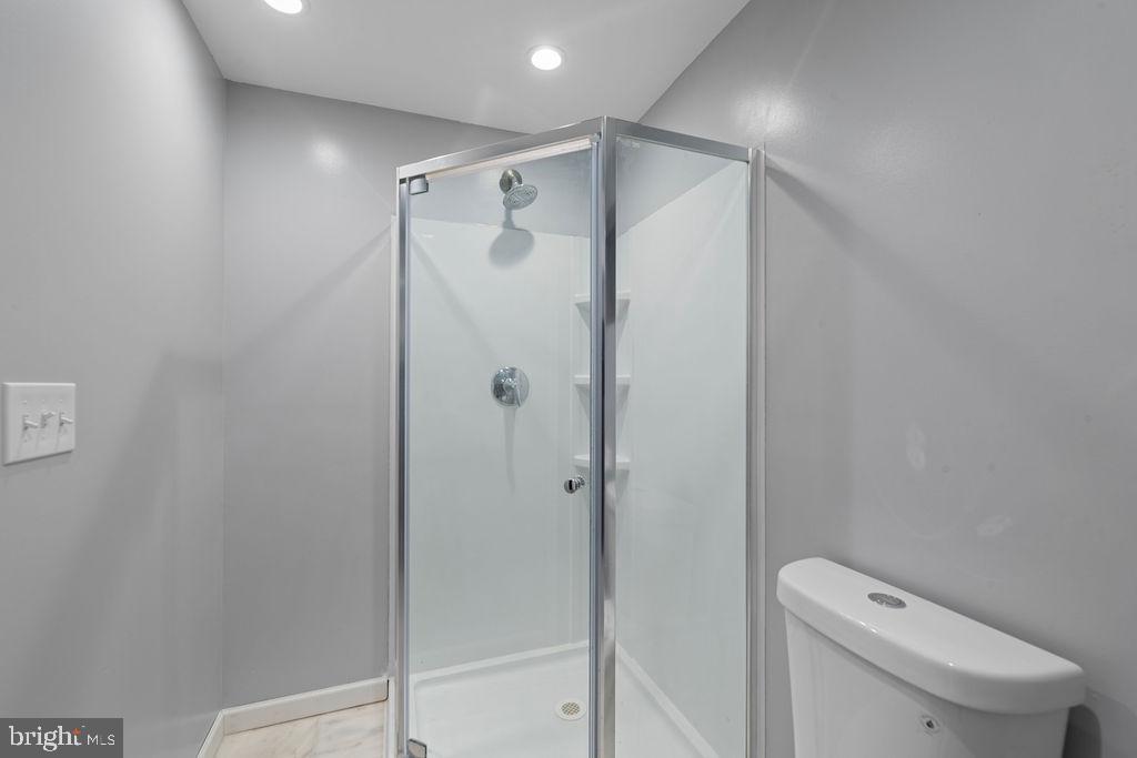 8003 Allentown Road Fort Washington, MD 20744 - Photo 31 of 43 a bathroom with a shower a toilet and sink