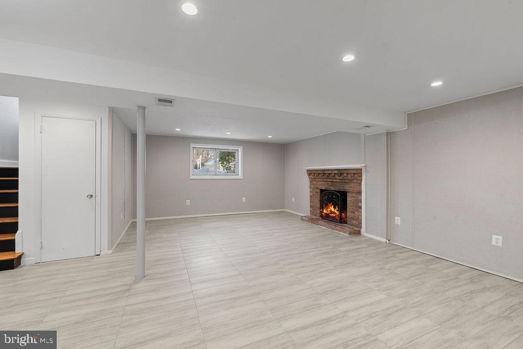 8003 Allentown Road Fort Washington, MD 20744 - Photo 34 of 43 a view of an empty room with a fireplace and a window