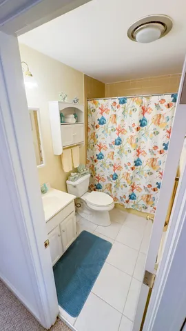 a bathroom with a sink a toilet and shower curtain
