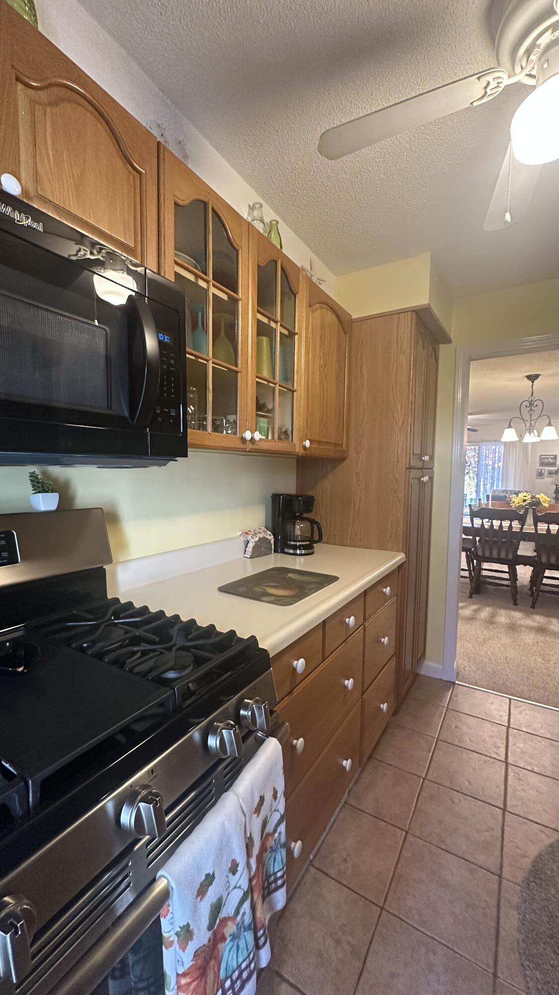 300 Buck Island Road, Unit 14F West Yarmouth, MA 02673 - Photo 6 of 27 a kitchen with a stove a sink and a microwave