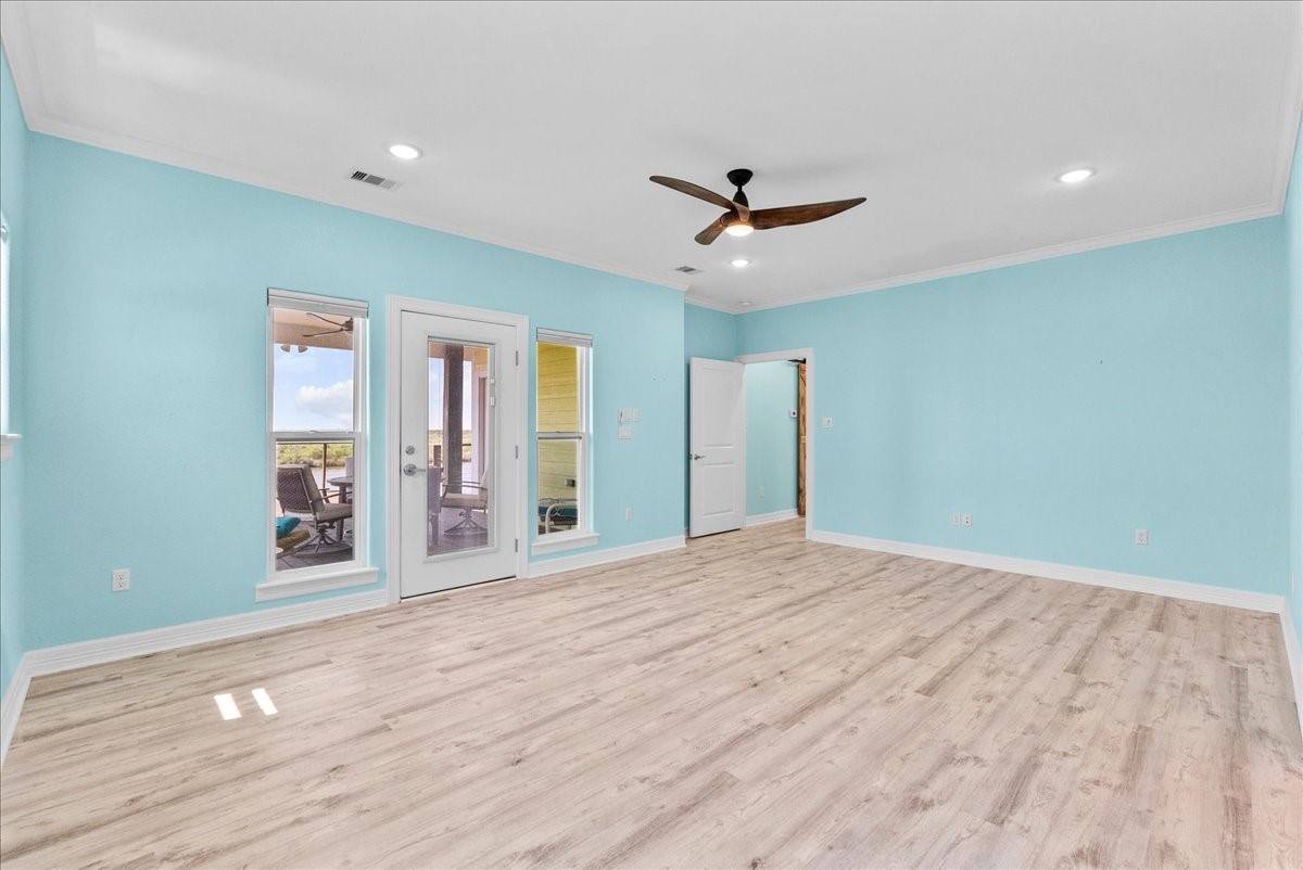 6 Trout Lane Freeport, TX 77541 - Photo 14 of 40 a view of an empty room with window and wooden floor