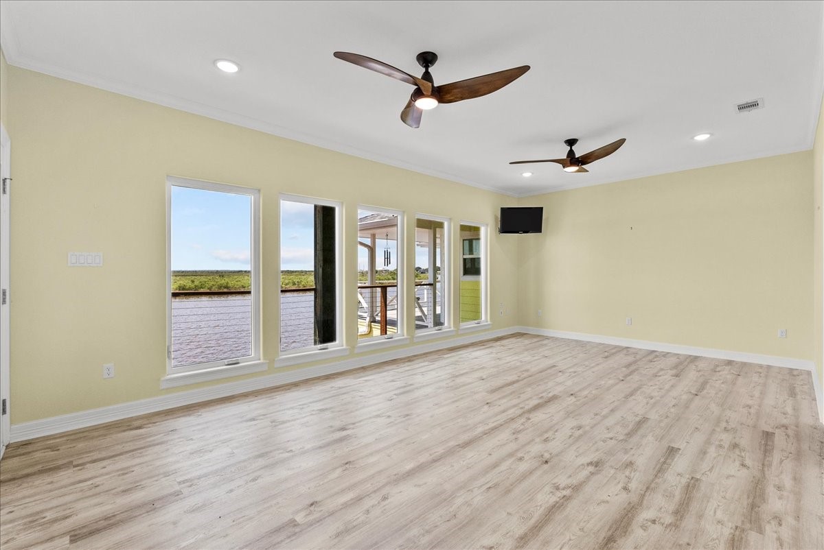 6 Trout Lane Freeport, TX 77541 - Photo 18 of 40 a view of an empty room with a window and wooden floor