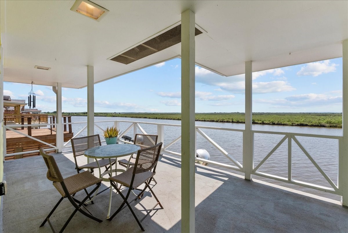 6 Trout Lane Freeport, TX 77541 - Photo 25 of 40 a dining room with furniture and a floor to ceiling window