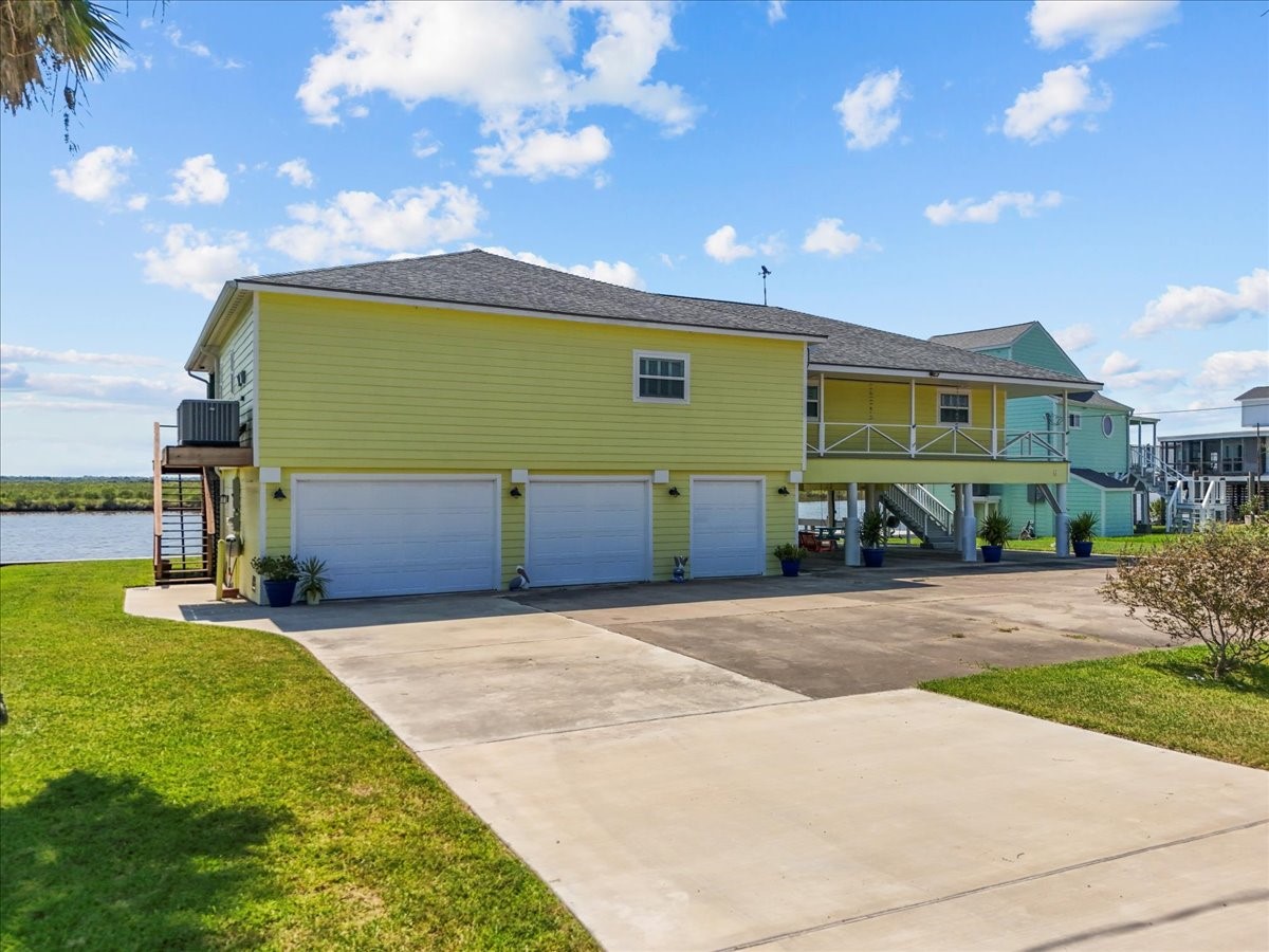 6 Trout Lane Freeport, TX 77541 - Photo 3 of 40 a front view of a house with a garden and yard