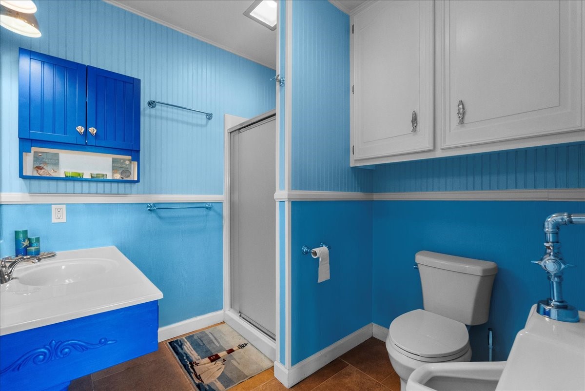 6 Trout Lane Freeport, TX 77541 - Photo 35 of 40 a bathroom with a toilet a sink and mirror