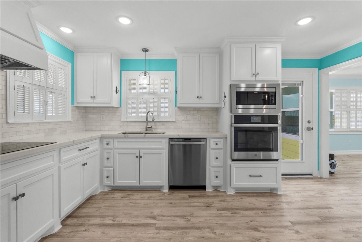 6 Trout Lane Freeport, TX 77541 - Photo 8 of 40 a kitchen with stainless steel appliances kitchen island granite countertop a stove and a sink