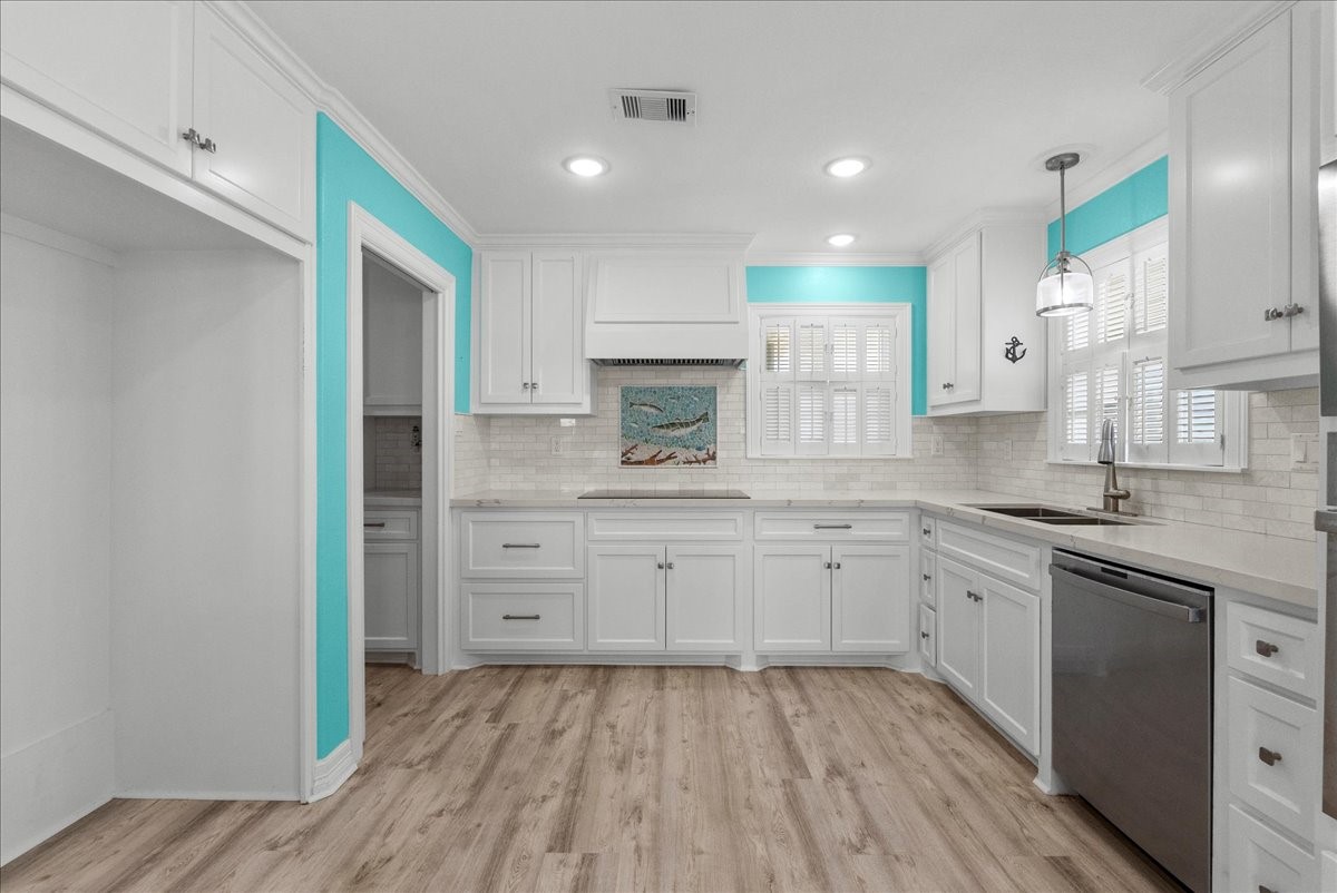 6 Trout Lane Freeport, TX 77541 - Photo 9 of 40 a kitchen with white cabinets and sink