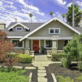 a front view of a house with yard and green space