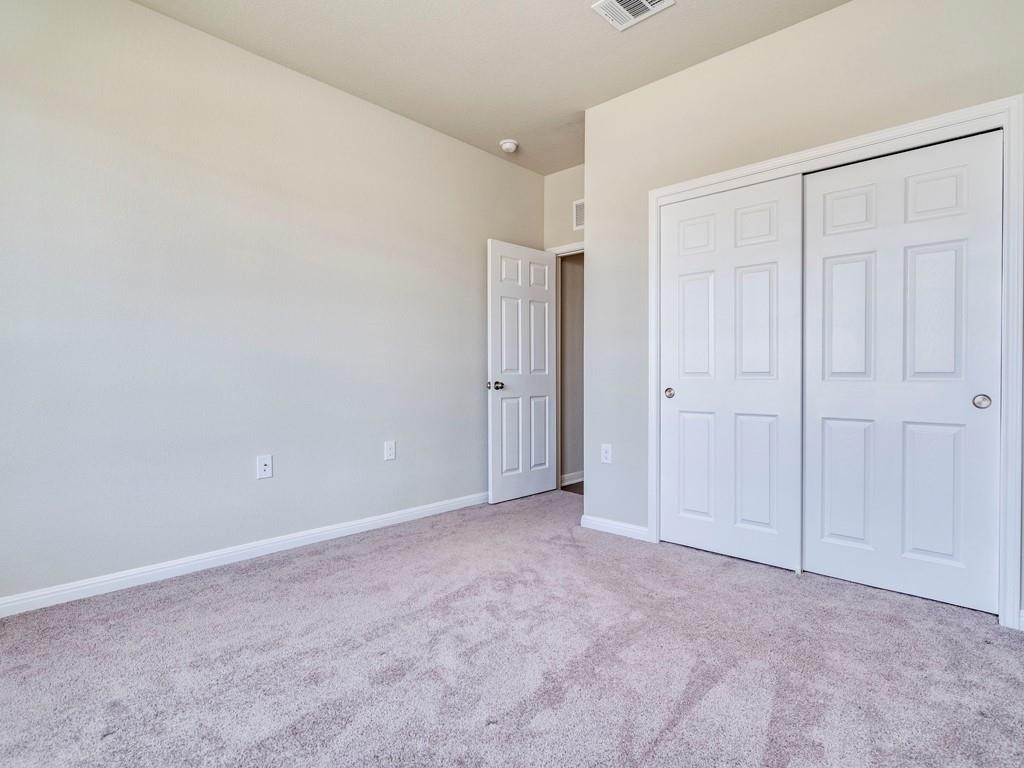 4210 Birdwatch Loop, Unit 2 Pflugerville, TX 78660 - Photo 22 of 31 A spacious, naturally illuminated room featuring plush carpeting and convenient closet access.