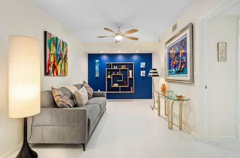 a living room with furniture and cabinets