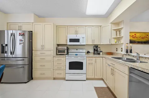 a kitchen with cabinets stainless steel appliances and a sink