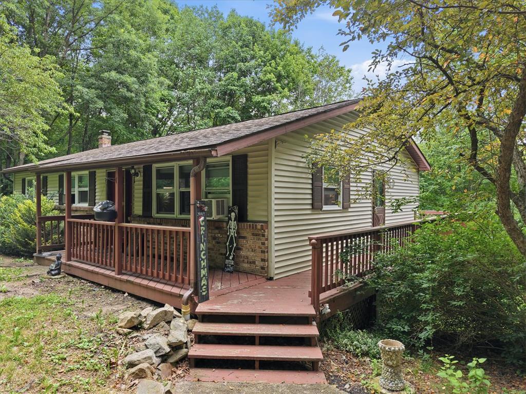 520 Highland Hill Road Jim Thorpe, PA 18235 - Photo 4 of 83 A charming cottage amidst lush greenery, featuring a welcoming porch and accessible ramp.