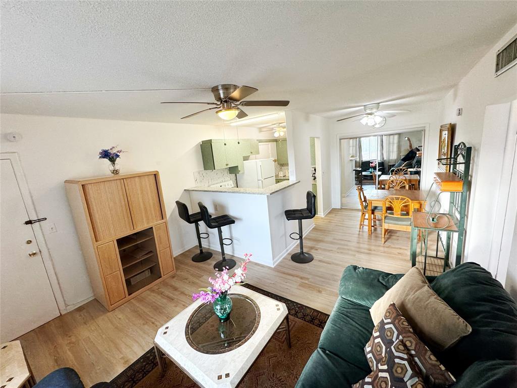 310 South Cypress Road, Unit 729 Pompano Beach, FL 33060 - Photo 13 of 30 a living room with furniture and a wooden floor