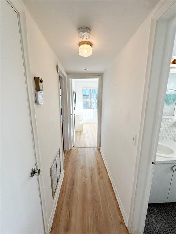 310 South Cypress Road, Unit 729 Pompano Beach, FL 33060 - Photo 16 of 30 a view of a hallway with wooden floor and staircase