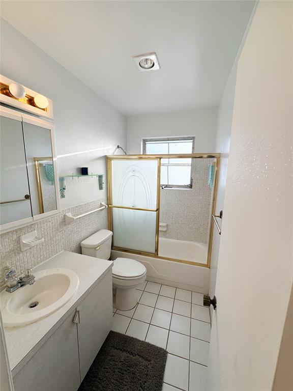 310 South Cypress Road, Unit 729 Pompano Beach, FL 33060 - Photo 17 of 30 a bathroom with a sink toilet and shower
