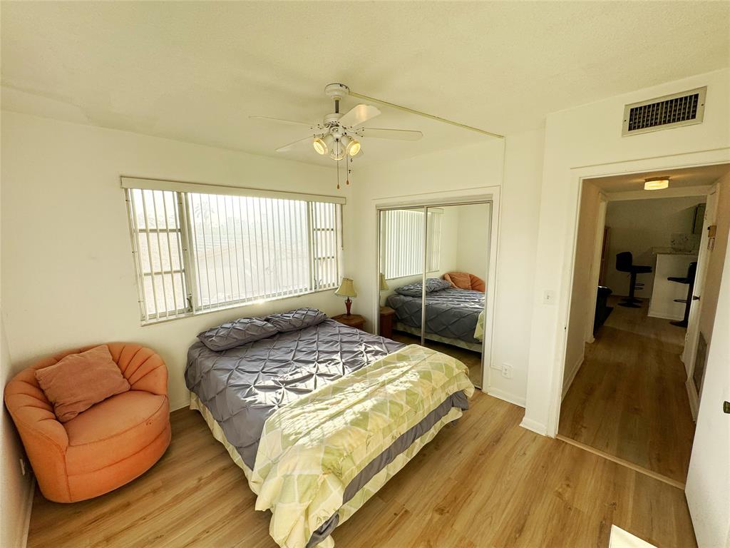 310 South Cypress Road, Unit 729 Pompano Beach, FL 33060 - Photo 19 of 30 a bedroom with a bed couch and window
