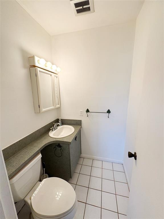 310 South Cypress Road, Unit 729 Pompano Beach, FL 33060 - Photo 21 of 30 a bathroom with a toilet a sink and mirror